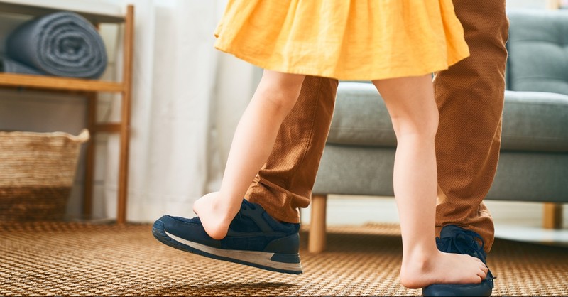 Daughter dancing on her father's feet