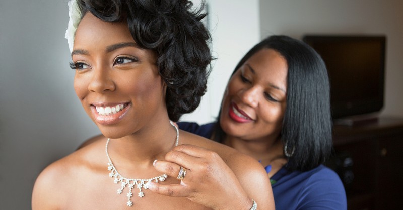 mother of the bride and the bride getting dressed