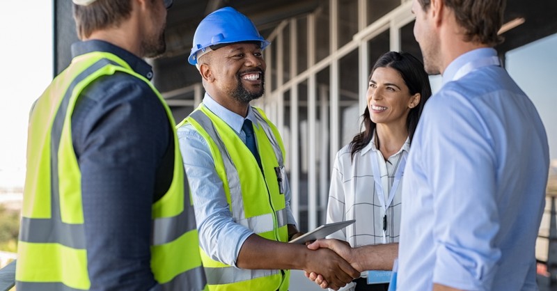 Workers and businessmen shaking hands