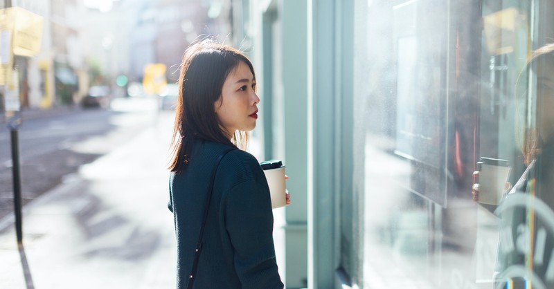 Woman looking into glass store window, envy vs. jealousy; the tenth commandment.