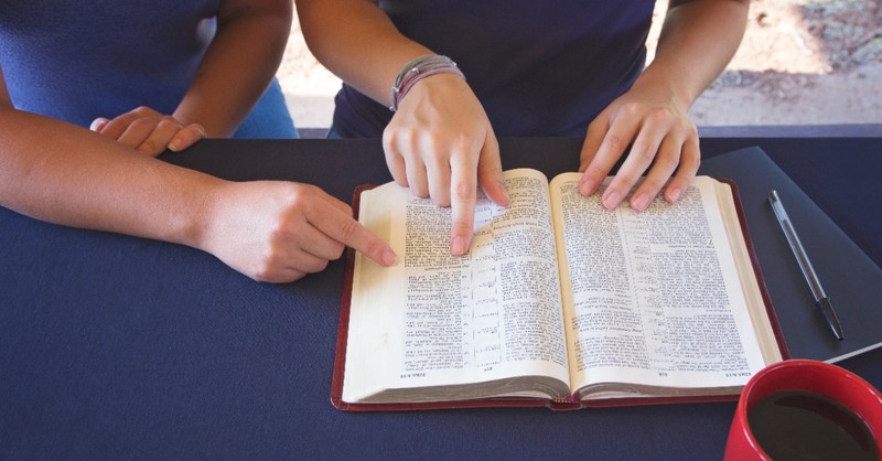 People sharing a Bible