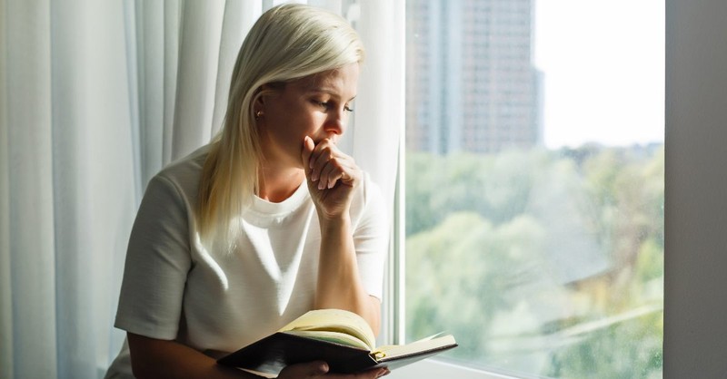 Woman reading her Bible; the third commandment.