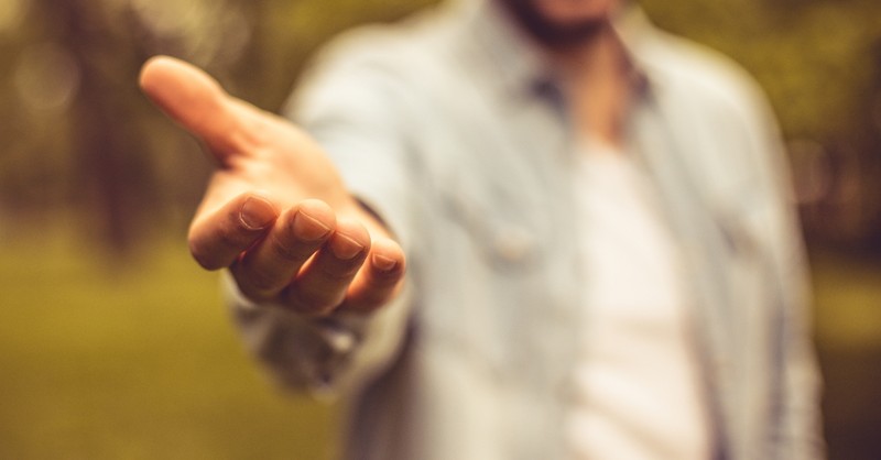 Close-up of a man offering a helping hand, grace and inclusion in bible family trees