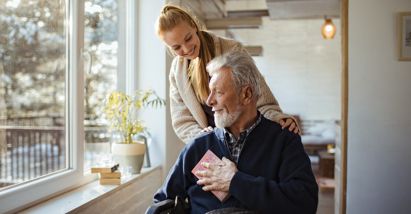 Adult Granddaughter with senior grandpa in wheelchair