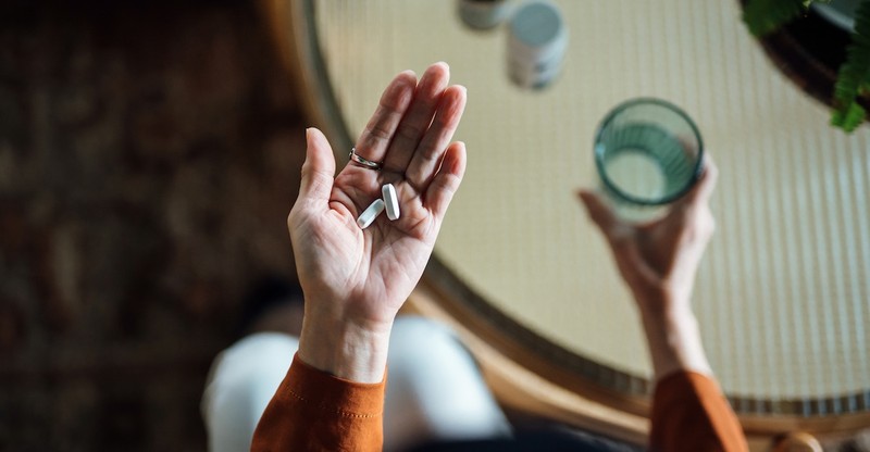 Woman taking prescription medication medicine for mental health