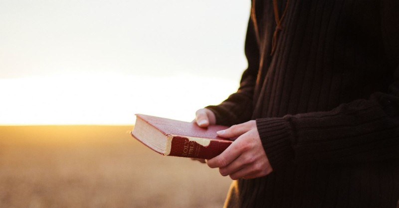 Man holding a Bible; The Ten Commandments.